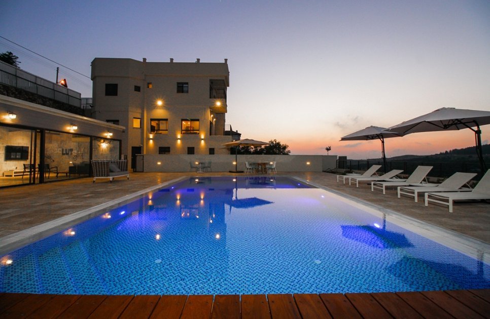 The pool and the villa at sunset in the Western Galilee