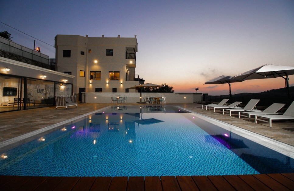 The pool in front of the villa in the evening