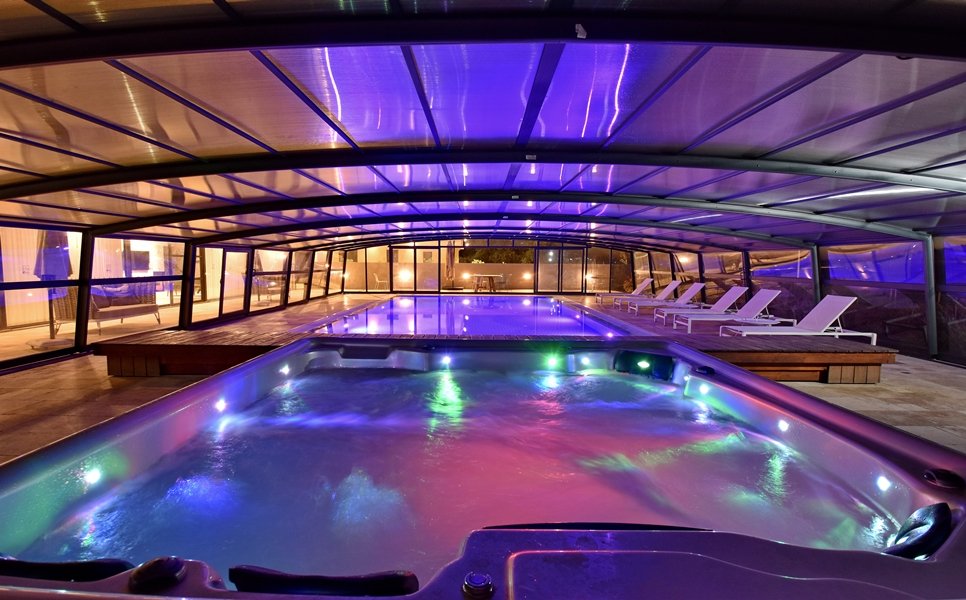 Jacuzzi and pool lit up at night